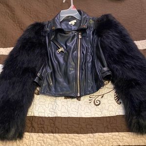It’s a size M and it’s leather with furry sleeves Brand from The Sang